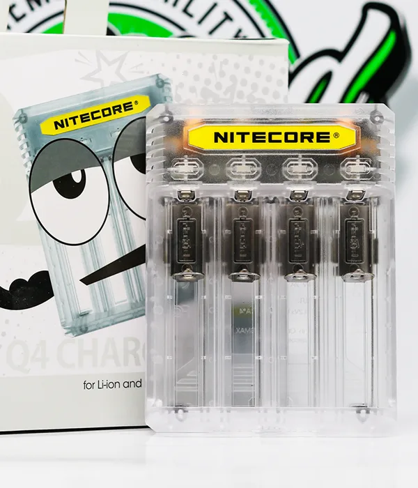 Clear Nitecore Q4 four-bay charger beside its white retail box printed with the cartoon Q4 Charger face