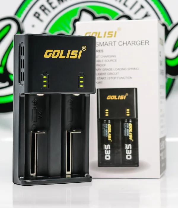 Black Golisi O2 two-bay charger beside its retail box showing two batteries seated in the charging slots