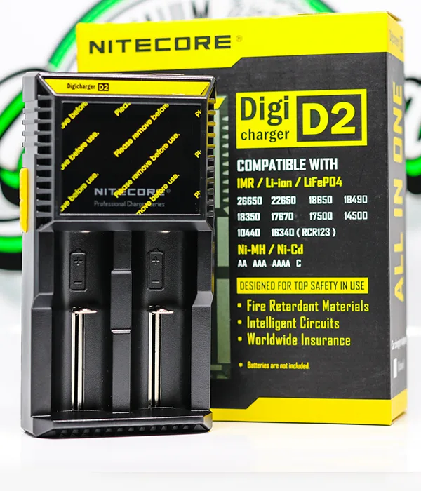 Nitecore D2 two-bay charger standing beside its yellow and black Digicharger retail box listing compatible battery sizes