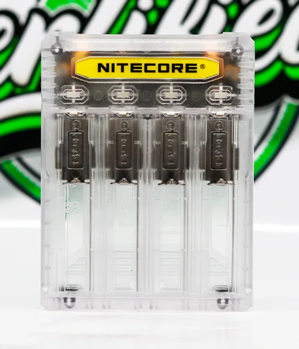 Top view of the transparent Nitecore Q4 charger showing four empty bays, dark sliding contacts and a yellow Nitecore badge