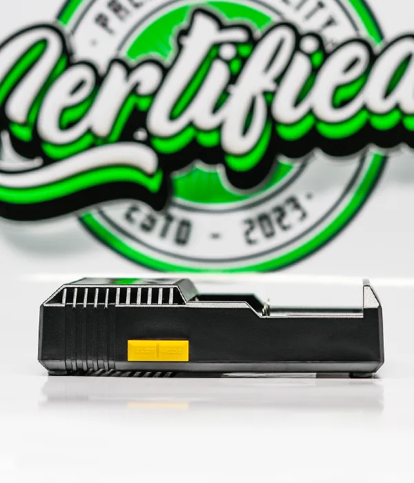 Side profile of the black Nitecore D2 charger showing its ribbed cooling vents and a small yellow label on the housing