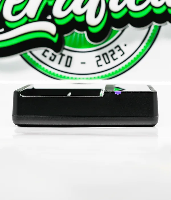 Side profile of the black Efest LUC V6 charger showing its slim glossy casing and the purple button on the top edge