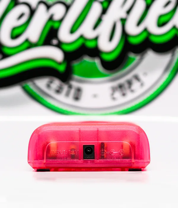 Close-up of the rear edge of the hot pink Nitecore Q4 charger showing the recessed DC power input socket