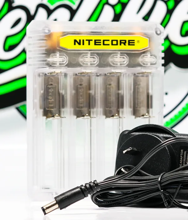 Clear Nitecore Q4 charger pictured with a black plug-in mains adapter and a coiled lead ending in a barrel plug
