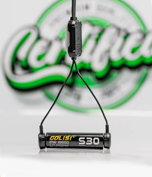 Golisi S30 IMR 18650 battery suspended by the two magnetic contact heads of the Nitecore LC10 charger