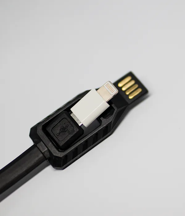 Macro view of the LC10 connector head with a white Lightning tip swung out beside the gold contacts of the USB-A plug